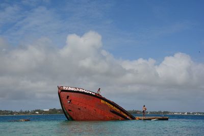 Boat sailing in sea against sky