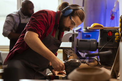 Side view of man working in workshop