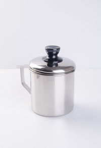 Close-up of kitchen utensil on table against white background