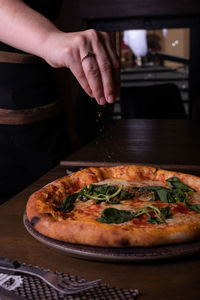 Cropped hand of person preparing food