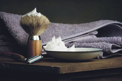 Close-up of shaving equipment on table