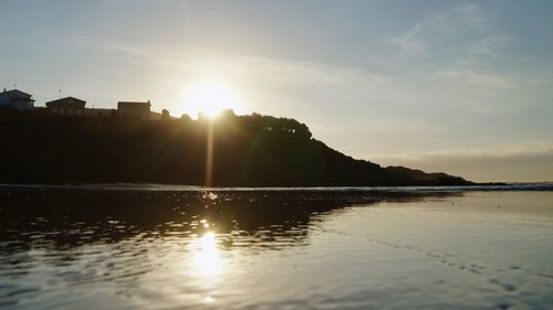 Scenic view of lake against sky during sunset