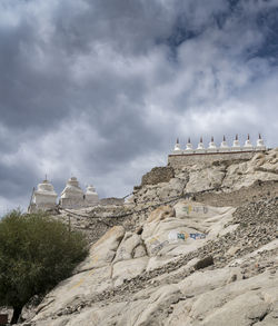 Low angle view of historical building against cloudy sky