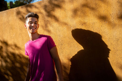 Portrait of smiling woman standing on beach