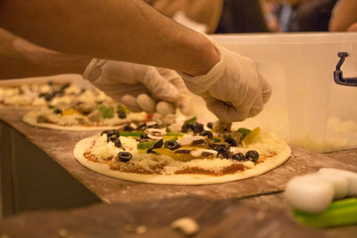 Close-up of hand holding pizza