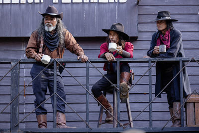 Early morning portrait of senior cowboys drinking coffee