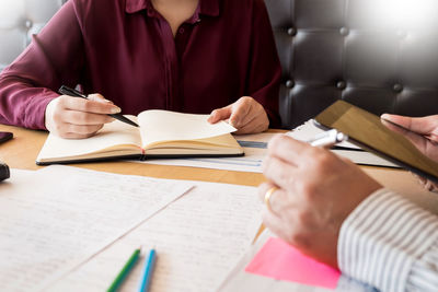 Cropped image of colleagues working in office