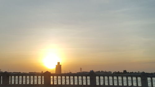 Silhouette built structure against sky during sunset