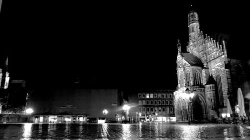 Reflection of illuminated buildings in water at night
