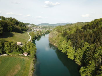 High angle view of river amidst trees against sky