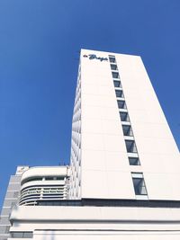 Low angle view of modern building against clear blue sky