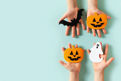 Kids hands with paper craft halloween toys