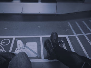 Low section of people sitting in subway train