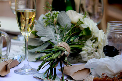 Close-up of bouquet and champagne flute on table