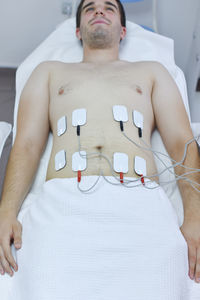 Midsection of man sitting on table