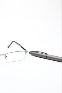 High angle view of eyeglasses on table against white background