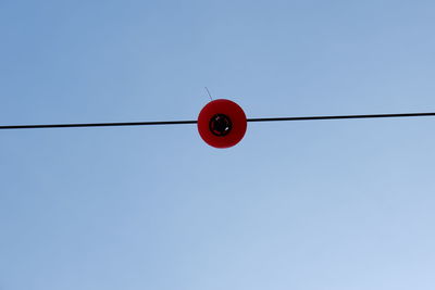 Low angle view of light bulb against clear sky