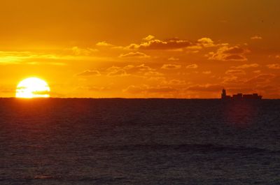 Scenic view of sea against orange sky