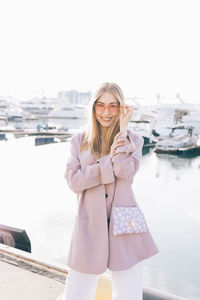 Young woman standing against the sky