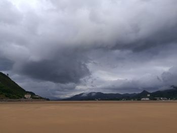 Scenic view of mountains against cloudy sky