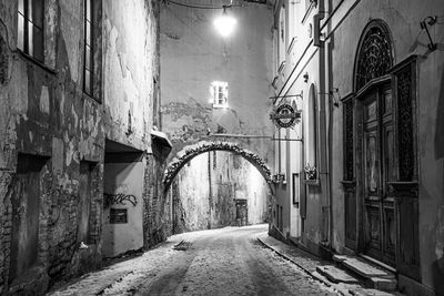 Empty alley amidst buildings in city