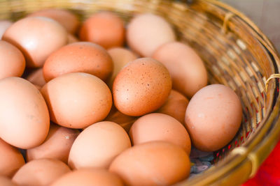 Close-up of brown eggs in wicker basket