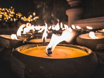 Close-up of lit candles in temple