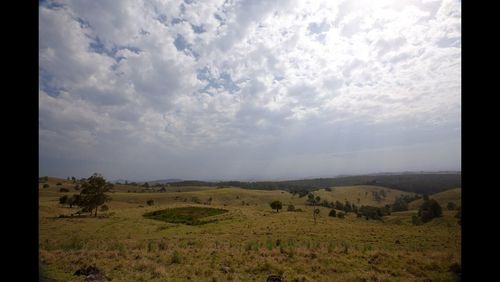 Scenic view of landscape against cloudy sky