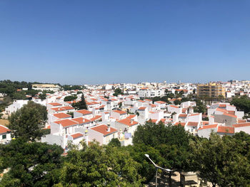 High angle view of townscape against clear blue sky