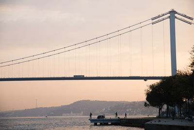 View of suspension bridge at sunset