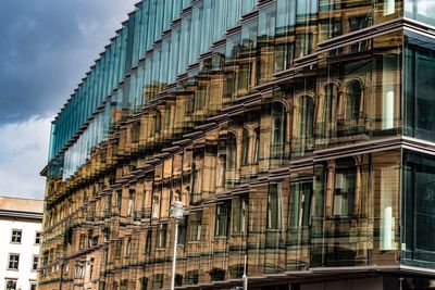 Low angle view of modern building in city against sky