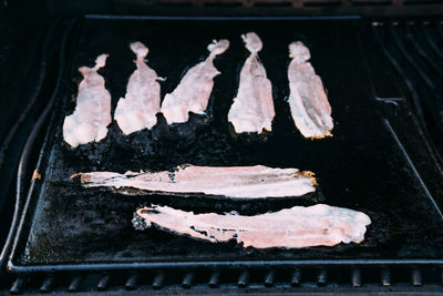 High angle view of meat on barbecue grill