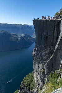 Preikestolen  famous tourist attraction in norway. steep cliff rises 604 metres  - 1982 feet high