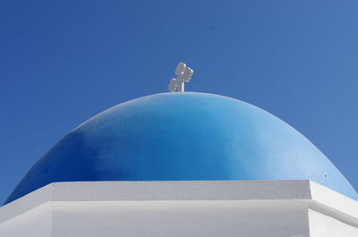 Low angle view of statue against blue sky