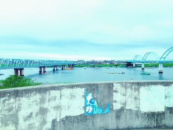 Bridge over canal against sky