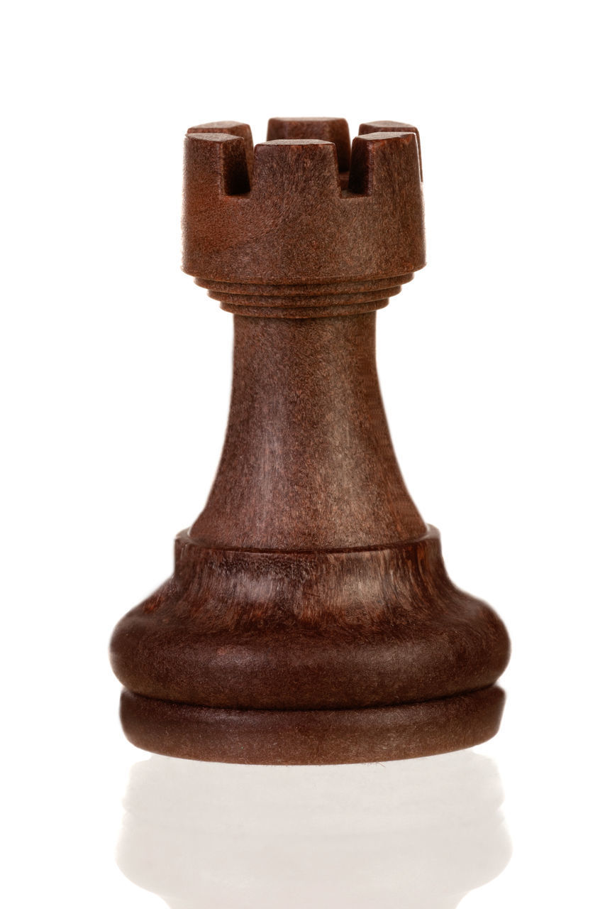 LOW ANGLE VIEW OF CHESS PIECES AGAINST WHITE BACKGROUND