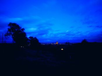 Silhouette trees against sky at dusk