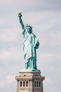 Low angle view of statue against cloudy sky