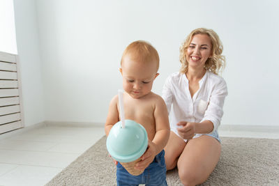 Mother playing with daughter at home