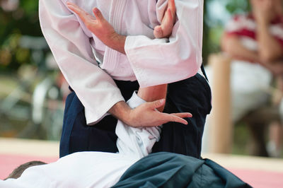 Midsection of men practicing karate in studio