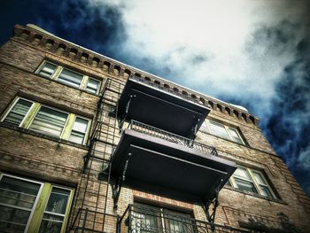 Low angle view of building against cloudy sky