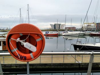 View of ship moored at harbor against sky