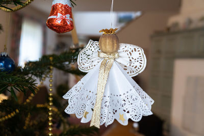 Close-up of decoration hanging on christmas tree at home