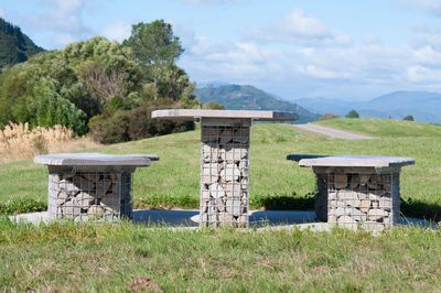 Picnic table made from rocks by river walking trail