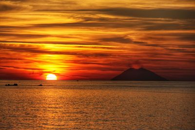 Scenic view of sea against orange sky
