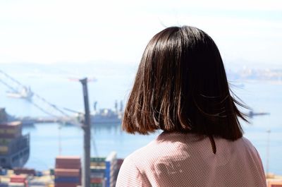 Rear view of woman standing against sky