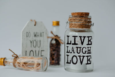 Close-up of glass jar on table against white background