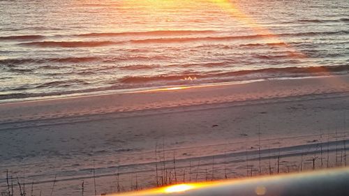 Scenic view of beach against sky during sunset