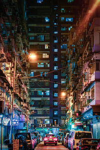 Illuminated city street and buildings at night