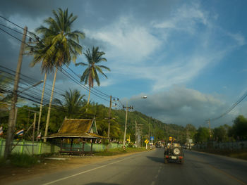 Cars on road against sky